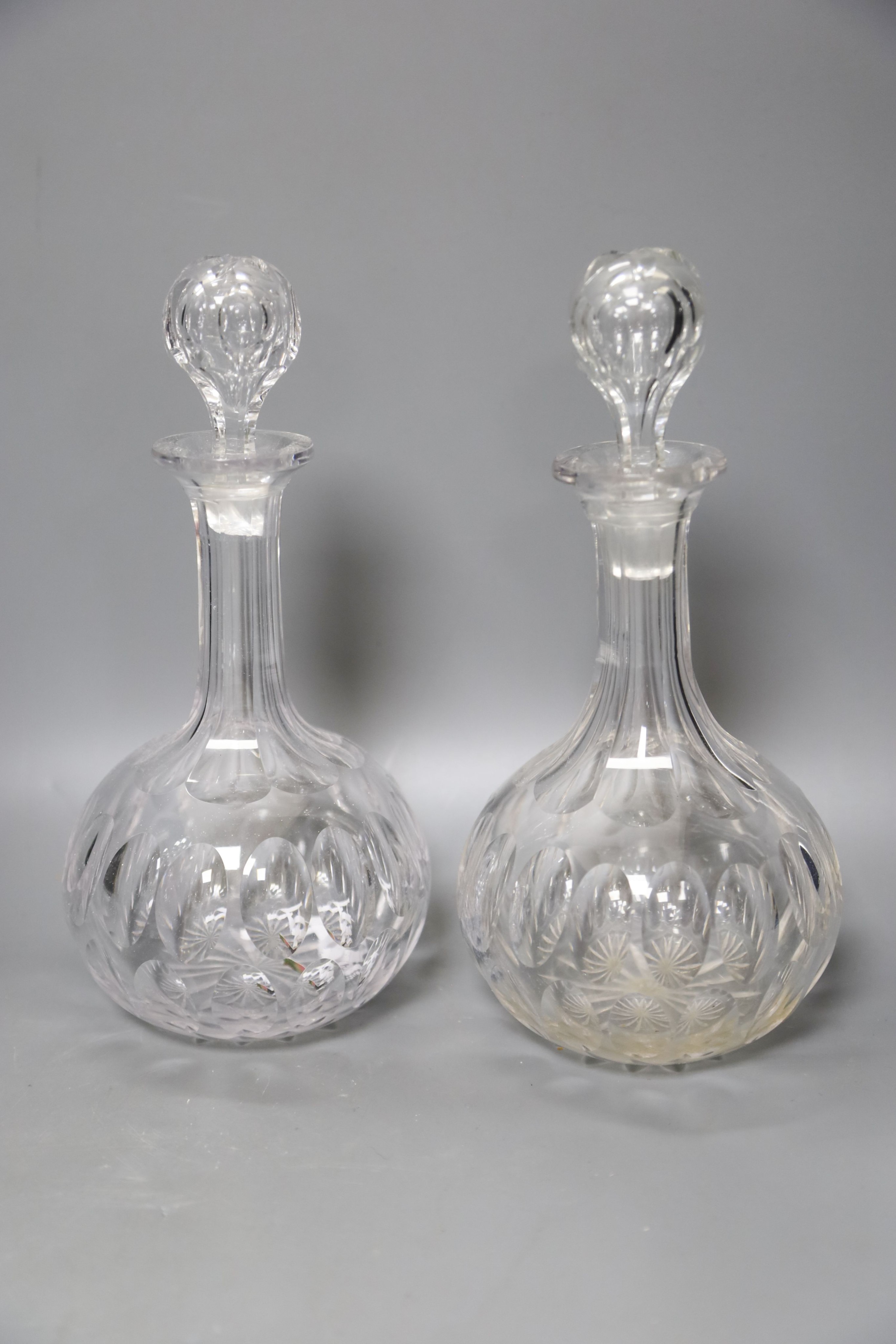 A pair of Regency small cut glass decanters, a pair of silver-mounted 'dimple' decanters, another pair of decanters and two other decanters.